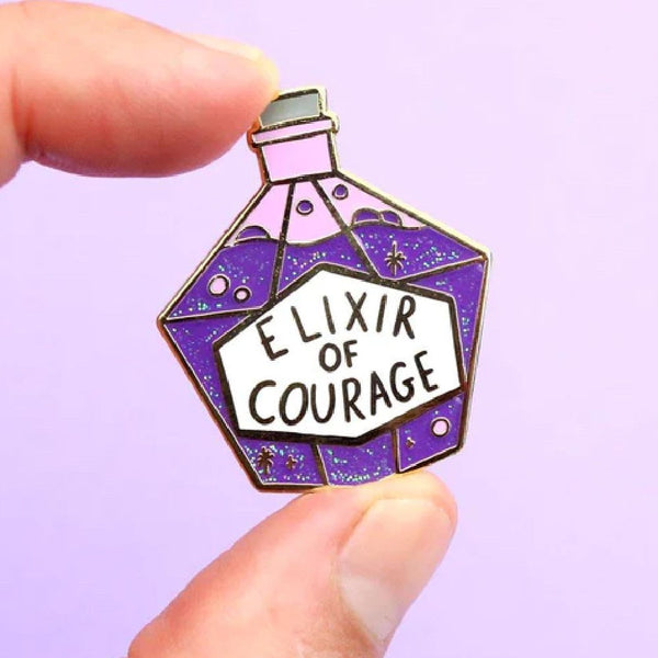 JUBLY-UMPH-Elixir-Of-Courage-Lapel-Pin-Between-Fingers