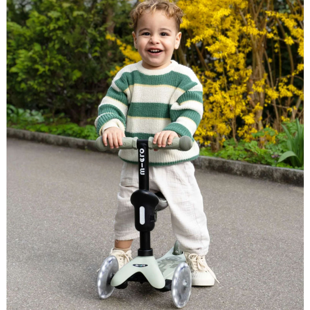 MICRO-Mini-Deluxe-Rock-and-Go-LED-Scooter-Lifestyle-View-Olive