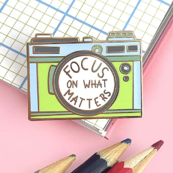JUBLY-UMPH-Focus-On-What-Matters-Lapel-Pin-On-Page