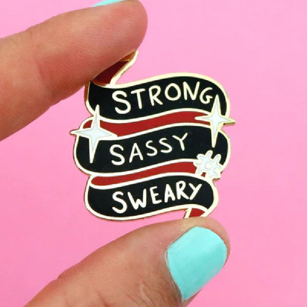 JUBLY-UMPH-Strong-Sassy-Sweary-Lapel-Pin-Between-Fingers