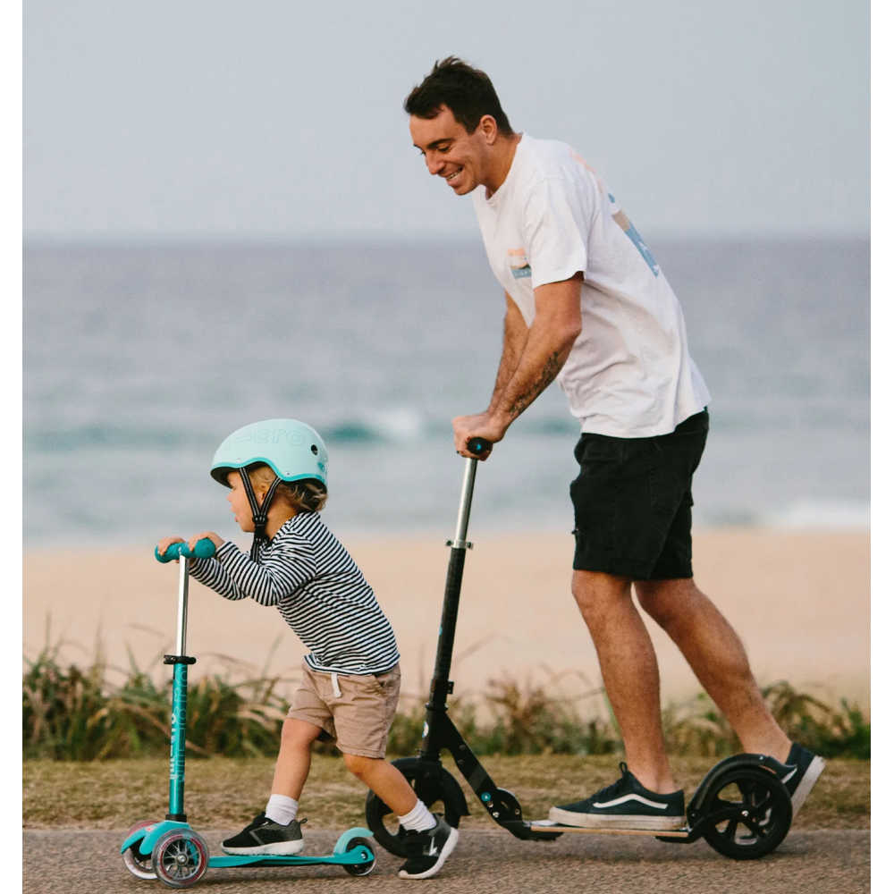 Micro-Scooters-Flex-Plus-Dad-And-Son-Riding-Scooter